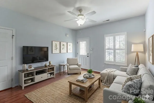 a living room with furniture and a flat screen tv