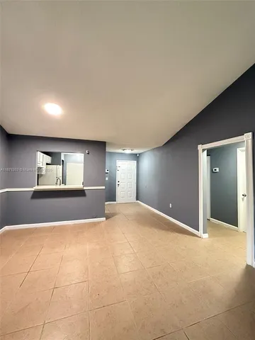 a view of empty room with window and fireplace