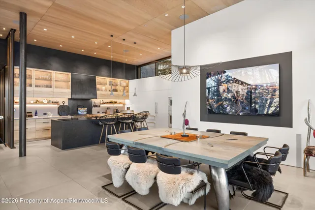 a view of a patio with table and chairs potted plants and large tree