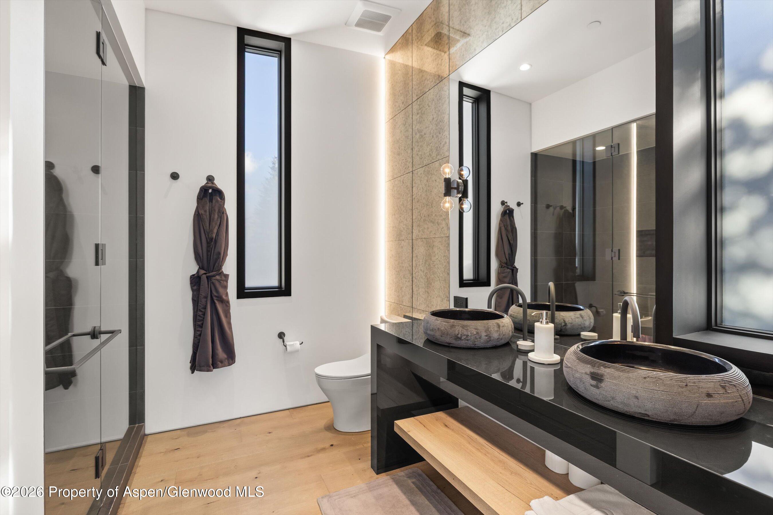 296 Glen Dee Road Aspen, CO 81611 - Photo 33 of 59 a bathroom with a double vanity sink and a mirror