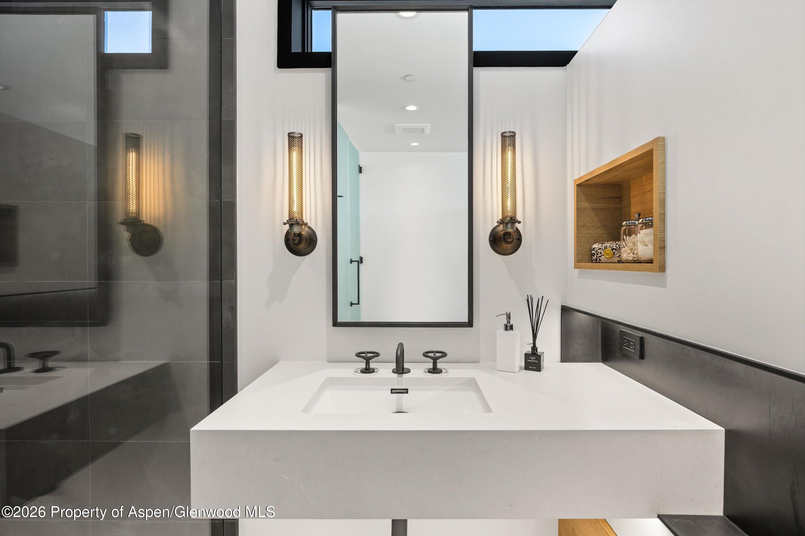 296 Glen Dee Road Aspen, CO 81611 - Photo 37 of 59 a bathroom with a sink a mirror and a shower