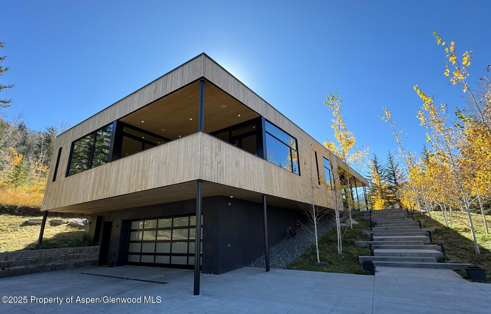 296 Glen Dee Road Aspen, CO 81611 - Photo 49 of 59 a front view of a house with a yard
