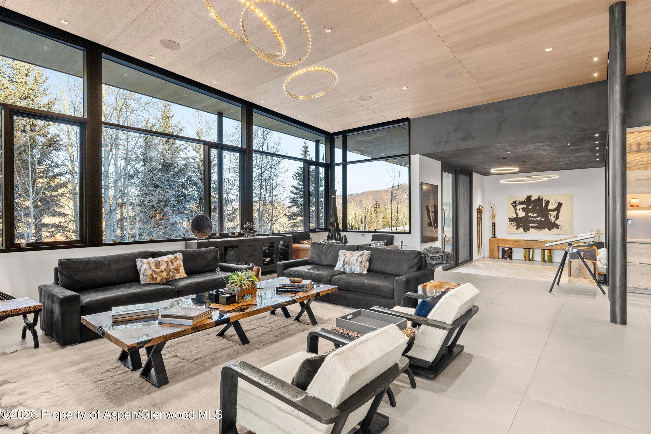 296 Glen Dee Road Aspen, CO 81611 - Photo 7 of 59 a living room with furniture and a floor to ceiling window