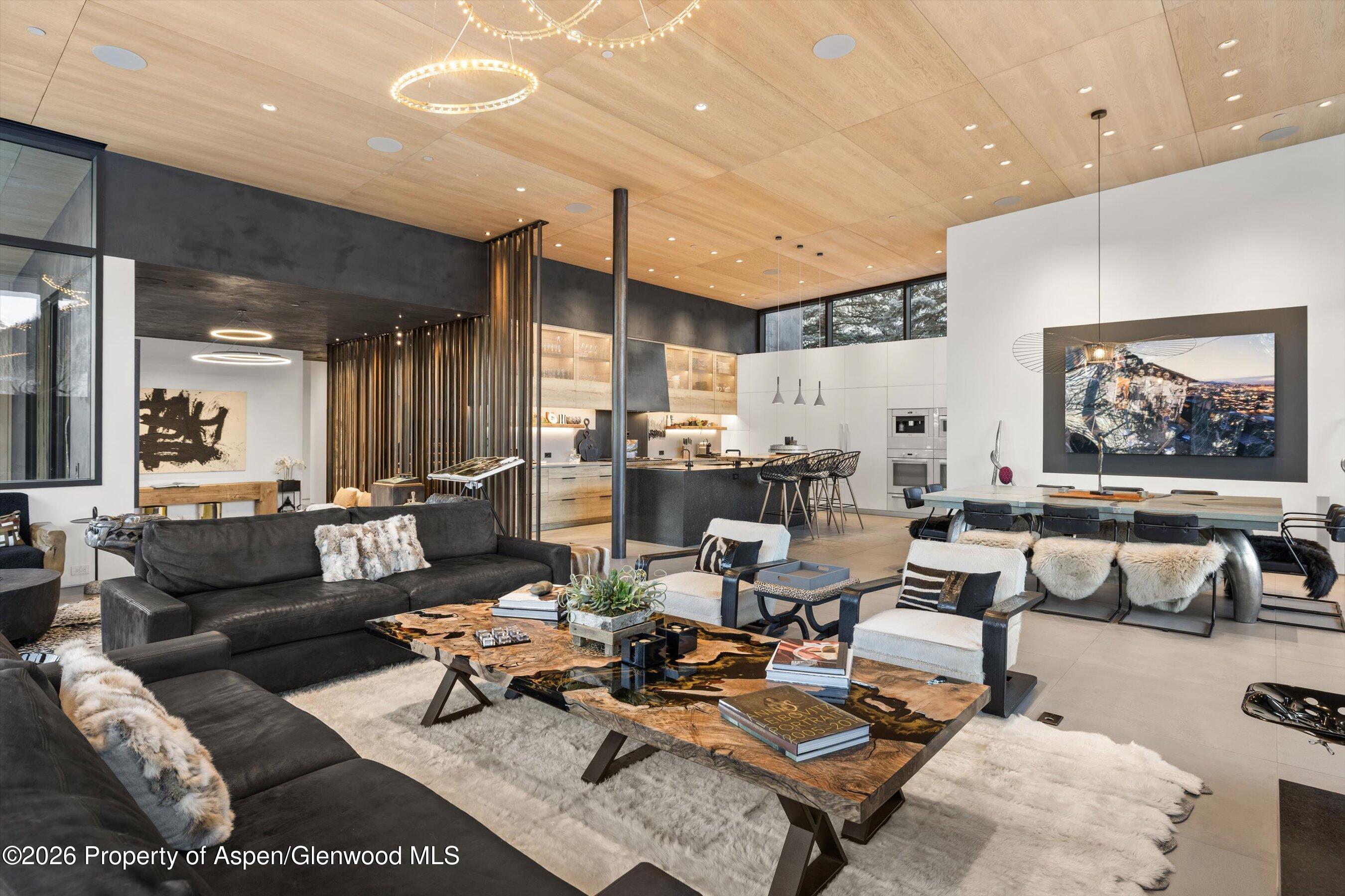 296 Glen Dee Road Aspen, CO 81611 - Photo 9 of 59 a living room with lots of furniture and a painting on the wall
