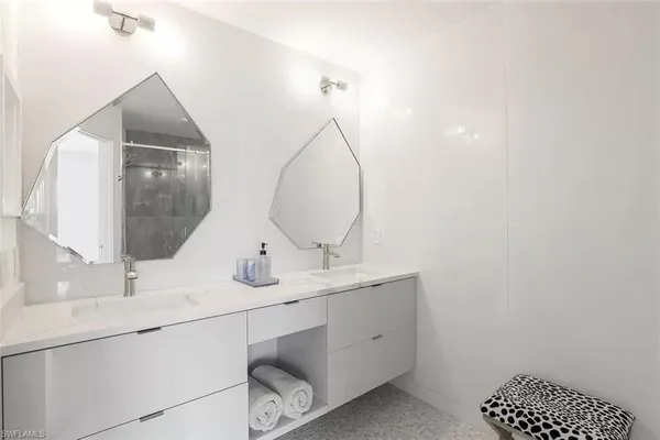 a bathroom with a double vanity sink and a mirror