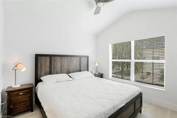 a bedroom with a large bed and a window