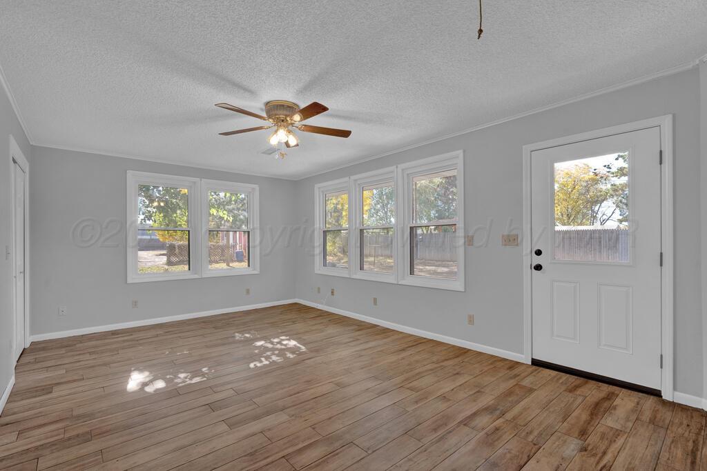 4231 Camp Lane Amarillo, TX 79110 - Photo 16 of 36 a view of an empty room with a window and wooden floor