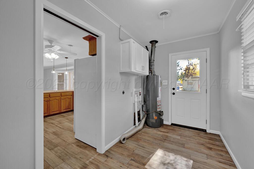 4231 Camp Lane Amarillo, TX 79110 - Photo 18 of 36 a view of a hallway with wooden floor and a living room