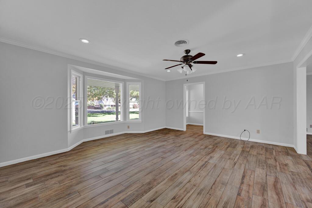 4231 Camp Lane Amarillo, TX 79110 - Photo 7 of 36 wooden floor in an empty room with a window
