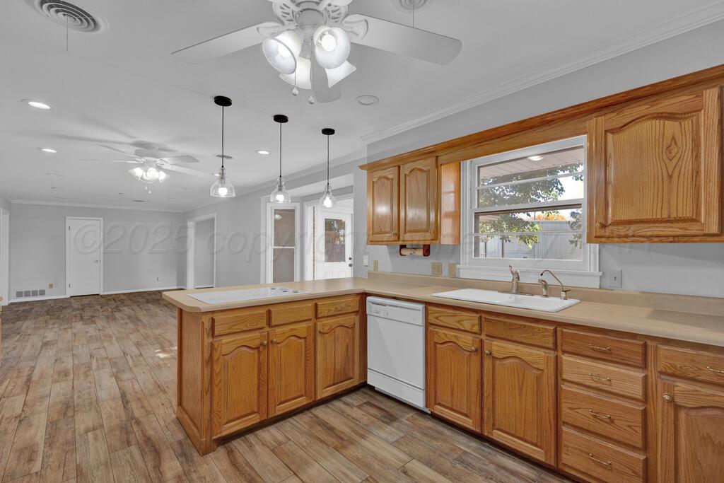 4231 Camp Lane Amarillo, TX 79110 - Photo 10 of 36 a view of a kitchen counter space a sink wooden floor and stainless steel appliances
