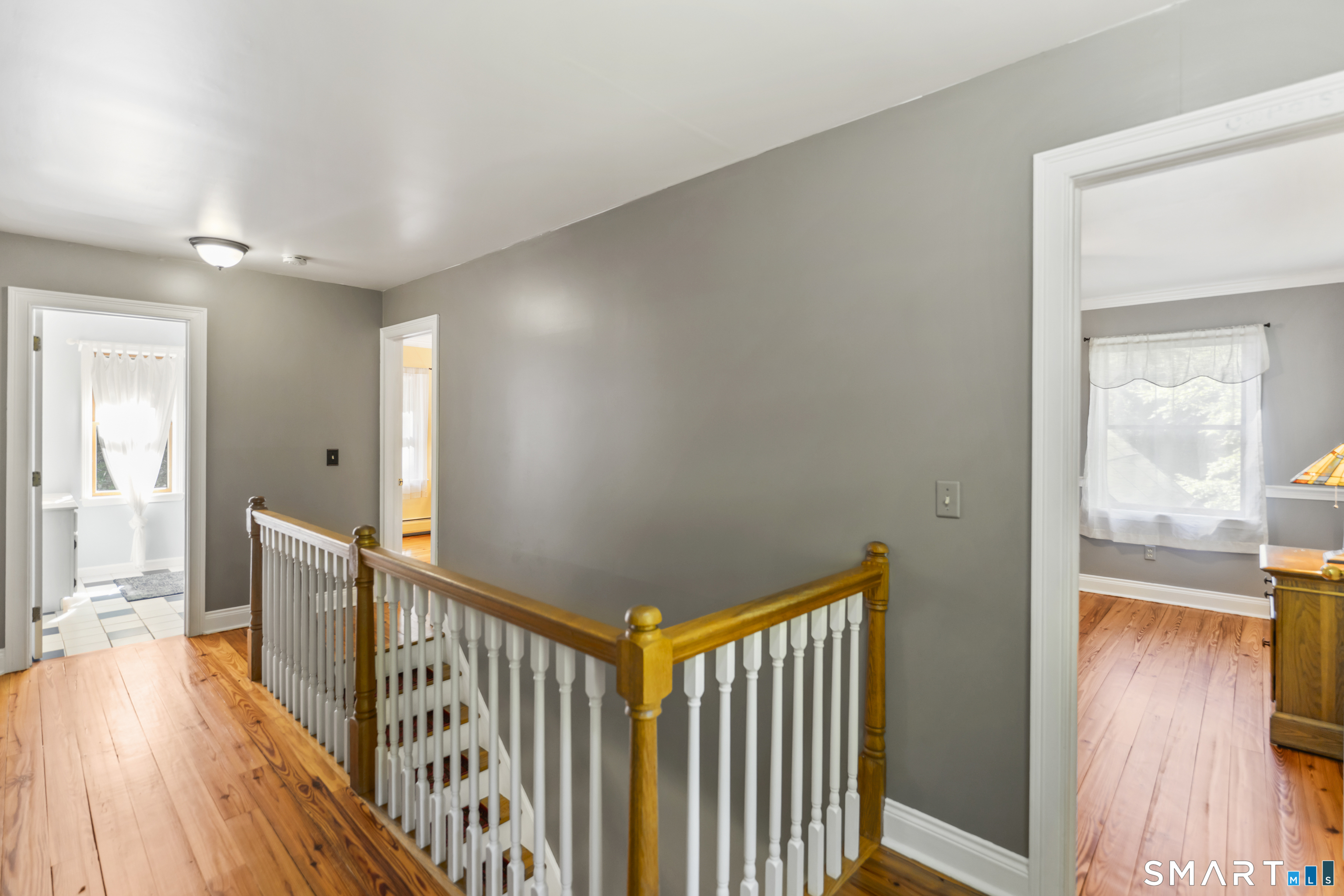 18 Gelding Hill Road Newtown, CT 06482 - Photo 21 of 40 a view of a hallway with wooden floor and windows