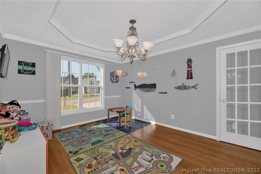 67 Chesapeake Road Cameron, NC 28326 - Photo 7 of 40 a view of a livingroom with wooden floor and a chandelier