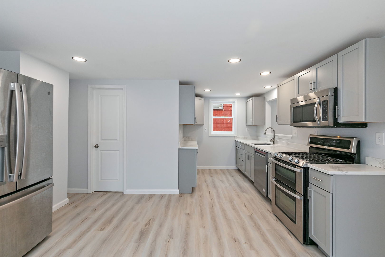 613 South 1st Street DeKalb, IL 60115 - Photo 11 of 21 a kitchen with stainless steel appliances a refrigerator a stove top oven a sink and cabinets