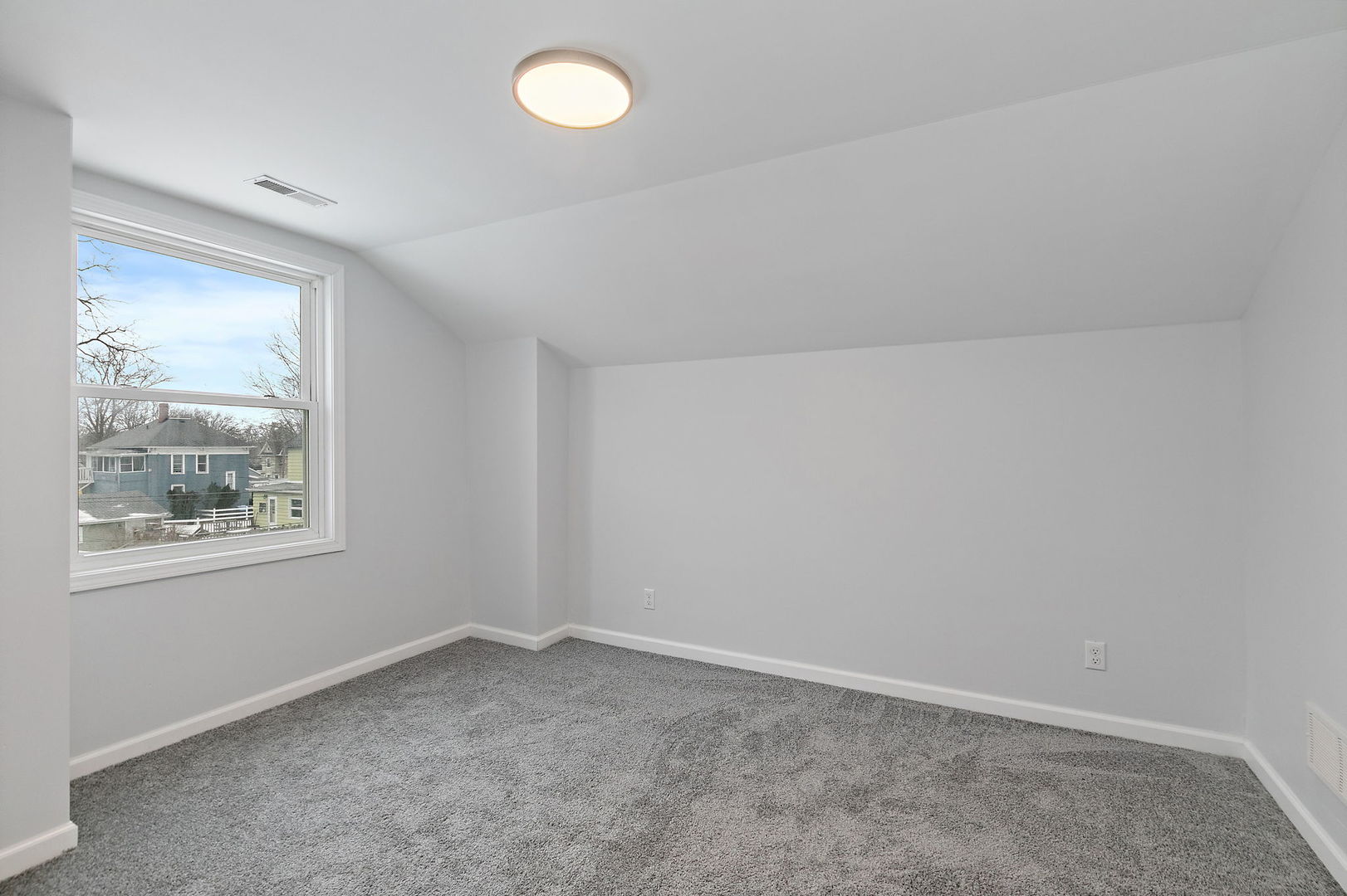 613 South 1st Street DeKalb, IL 60115 - Photo 16 of 21 an empty room with a window