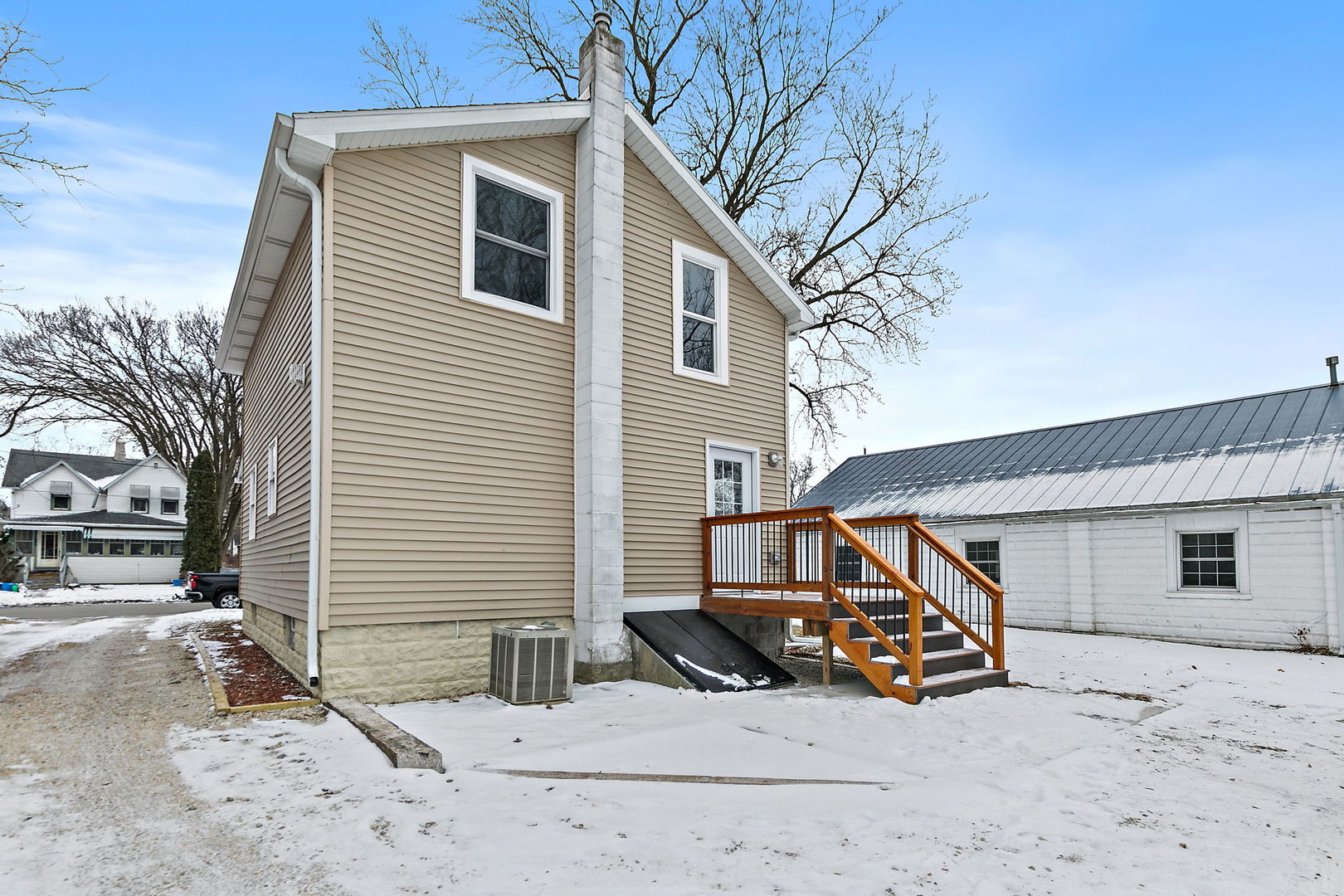 613 South 1st Street DeKalb, IL 60115 - Photo 20 of 21 a view of a house with a yard and a wooden deck