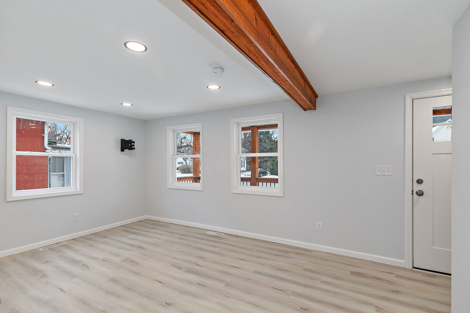 613 South 1st Street DeKalb, IL 60115 - Photo 2 of 21 a view of empty room with wooden floor and fan