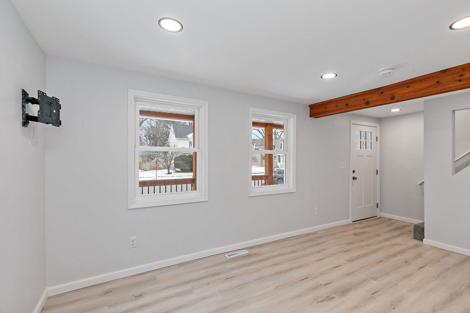 613 South 1st Street DeKalb, IL 60115 - Photo 3 of 21 a view of an empty room with wooden floor and a window