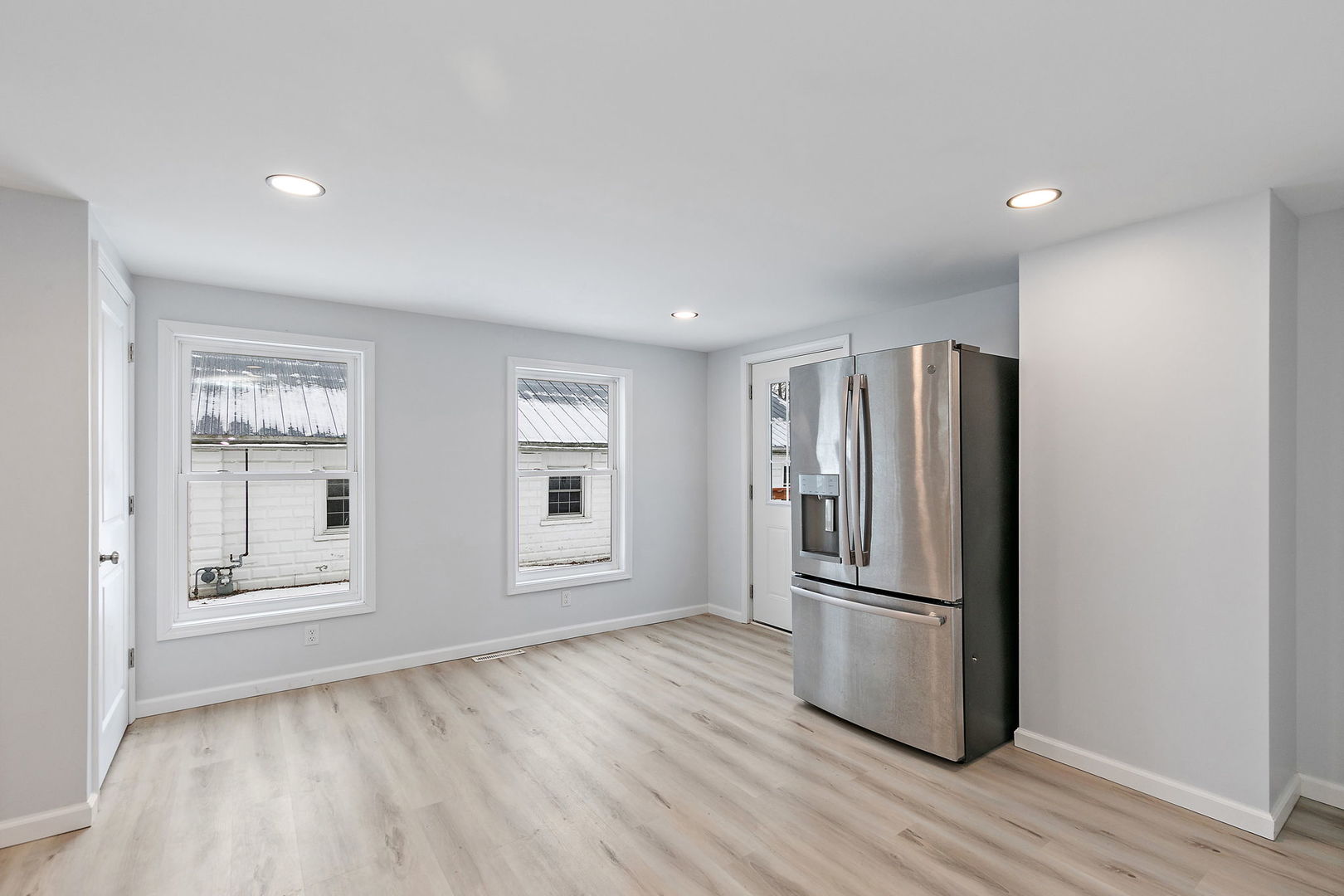 613 South 1st Street DeKalb, IL 60115 - Photo 9 of 21 a view of a kitchen with wooden floor and refrigerator