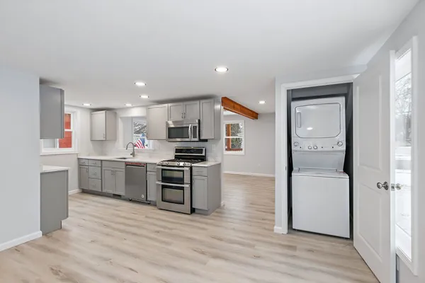 a kitchen with a refrigerator and a stove top oven