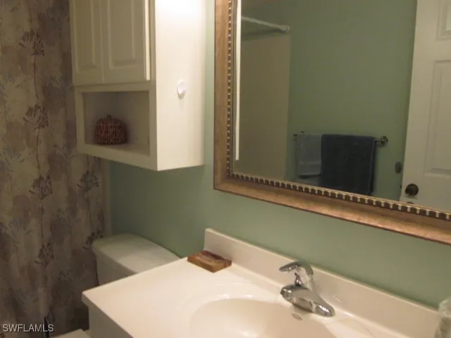 a bed room with a bed and a lamp