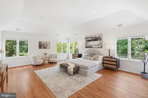a bedroom with furniture and a large window