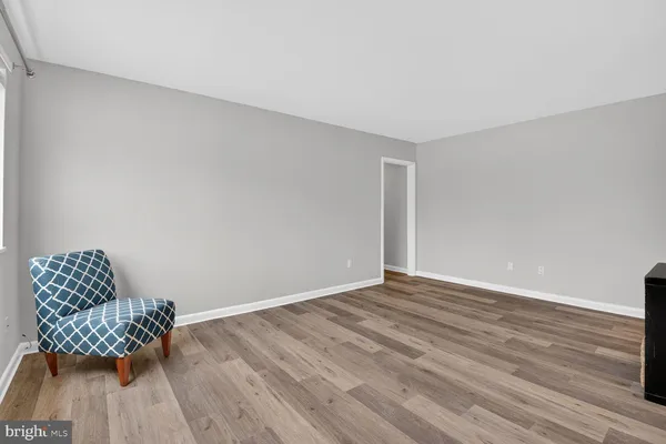 a view of room with furniture and wooden floor