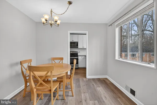 a view of a dining room with furniture wooden floor and chandelier