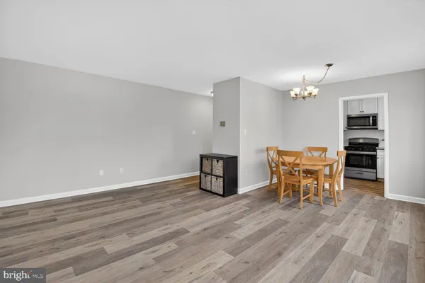 a view of a room with furniture and wooden floor