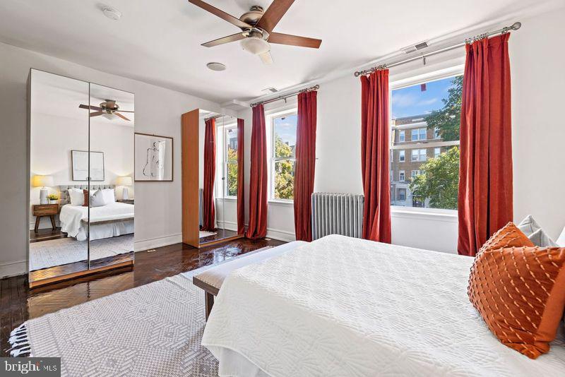 2530 13th Street Northwest Washington, DC 20009 - Photo 18 of 33 a bedroom with a bed and large windows