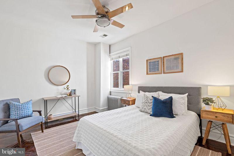 2530 13th Street Northwest Washington, DC 20009 - Photo 22 of 33 a bedroom with a bed a table and chair