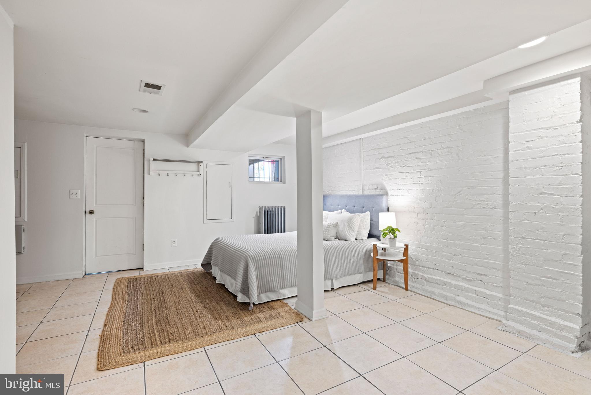 2530 13th Street Northwest Washington, DC 20009 - Photo 27 of 33 a bedroom with a bed and a lamp