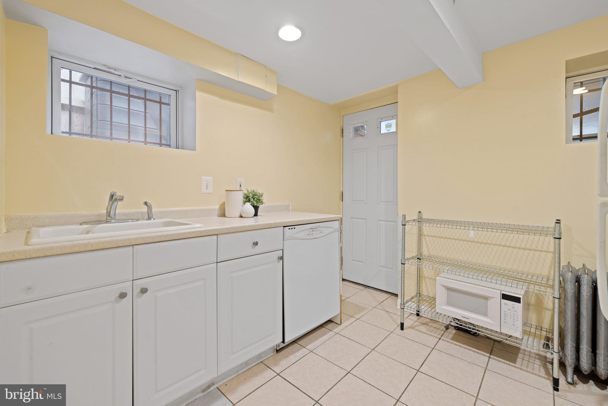 2530 13th Street Northwest Washington, DC 20009 - Photo 30 of 33 a spacious bathroom with a double vanity sink a mirror and a shower