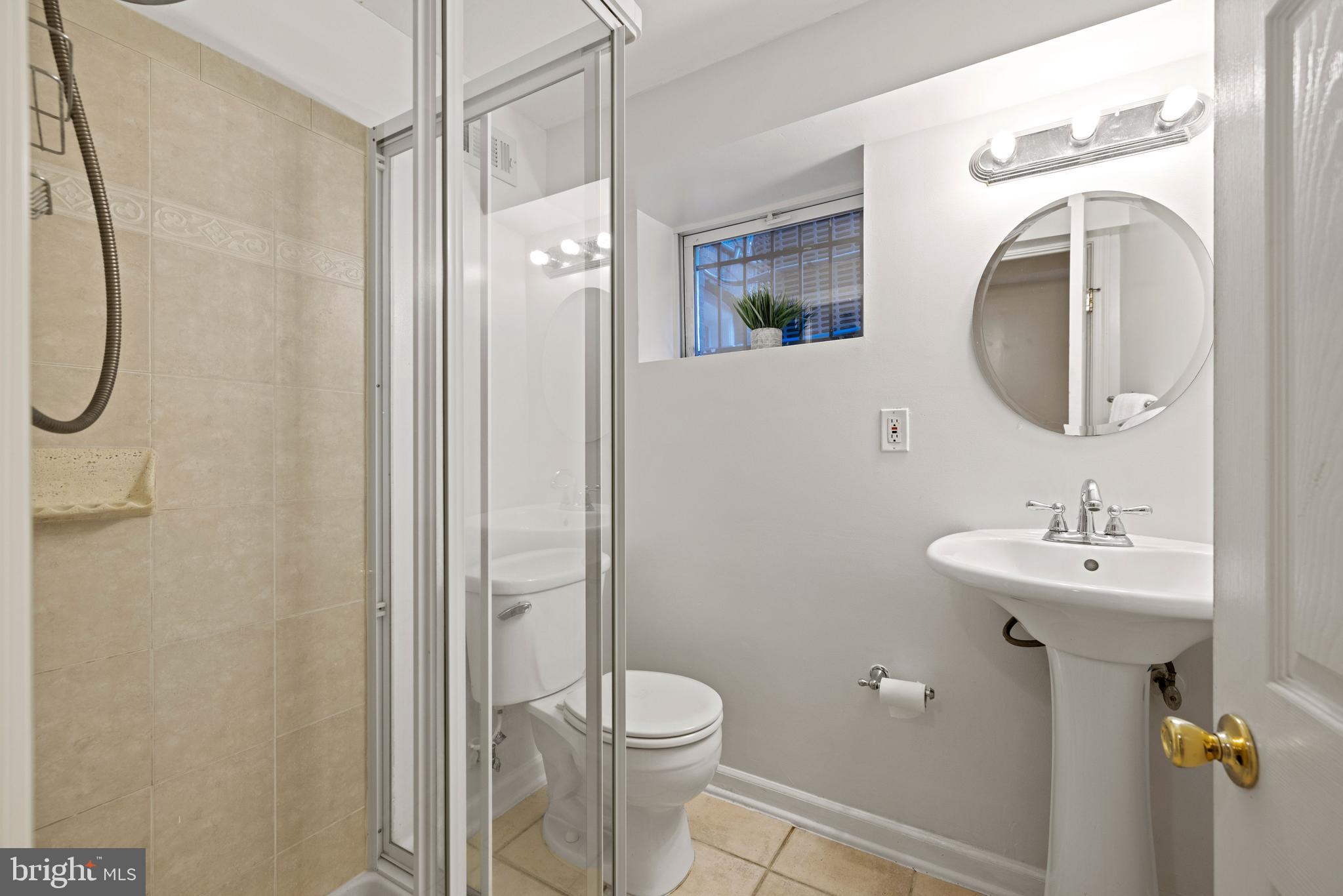 2530 13th Street Northwest Washington, DC 20009 - Photo 31 of 33 a bathroom with a sink a toilet and shower