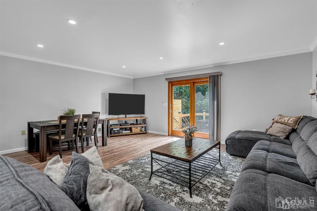 21 Bramble Lane Old Bridge, NJ 07747 - Photo 11 of 35 a living room with furniture and a flat screen tv with wooden floor