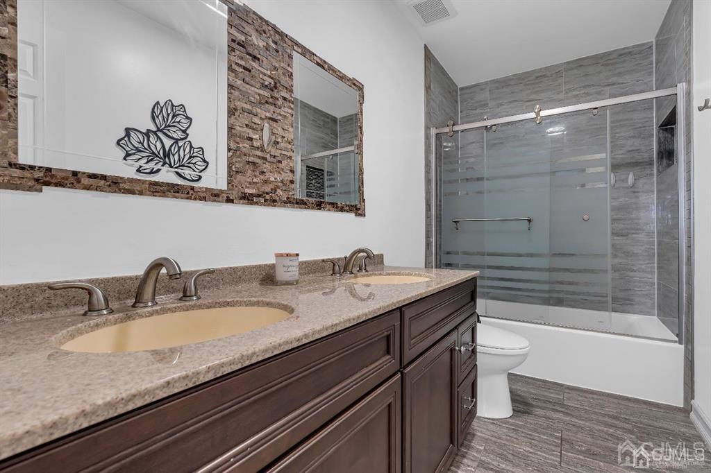 21 Bramble Lane Old Bridge, NJ 07747 - Photo 24 of 35 a bathroom with a granite countertop sink a toilet and bathtub