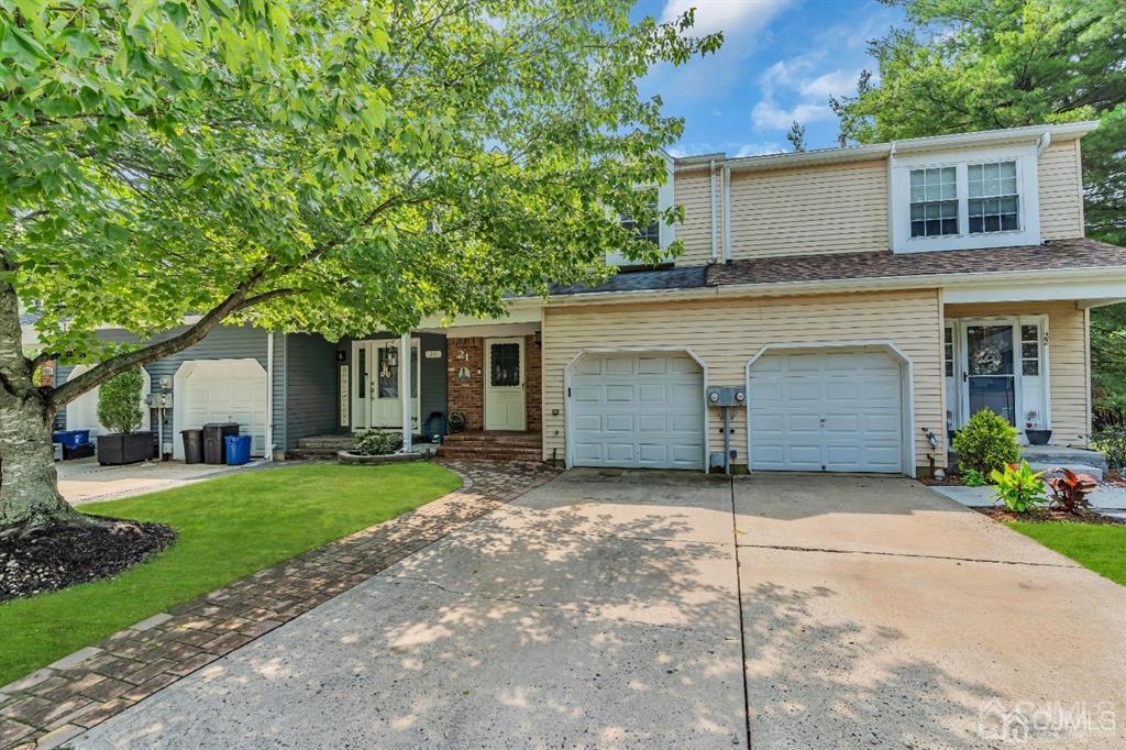 21 Bramble Lane Old Bridge, NJ 07747 - Photo 3 of 35 a front view of a house with a garden and trees