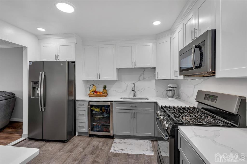21 Bramble Lane Old Bridge, NJ 07747 - Photo 7 of 35 a kitchen with stainless steel appliances granite countertop a refrigerator stove top oven and sink