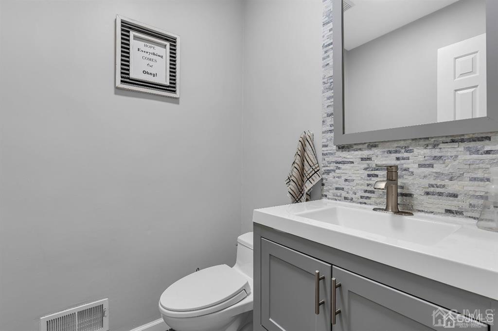 21 Bramble Lane Old Bridge, NJ 07747 - Photo 10 of 35 a bathroom with a sink a toilet and mirror