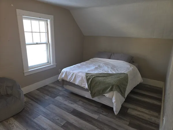 a bedroom with a bed and window