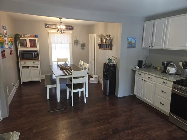 a view of a dining room kitchen with furniture and wooden floor