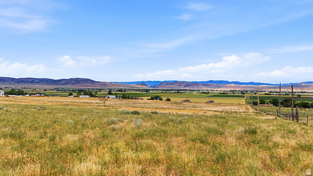 16013 North 6125th Street West Riverside, UT 84334 - Photo 5 of 10 Expansive open fields featuring natural grasses and distant mountain ranges