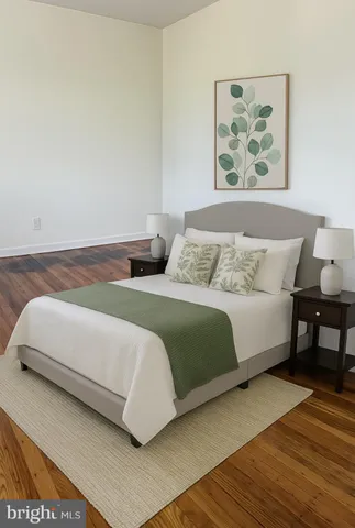 a bedroom with a bed and a painting on the wall