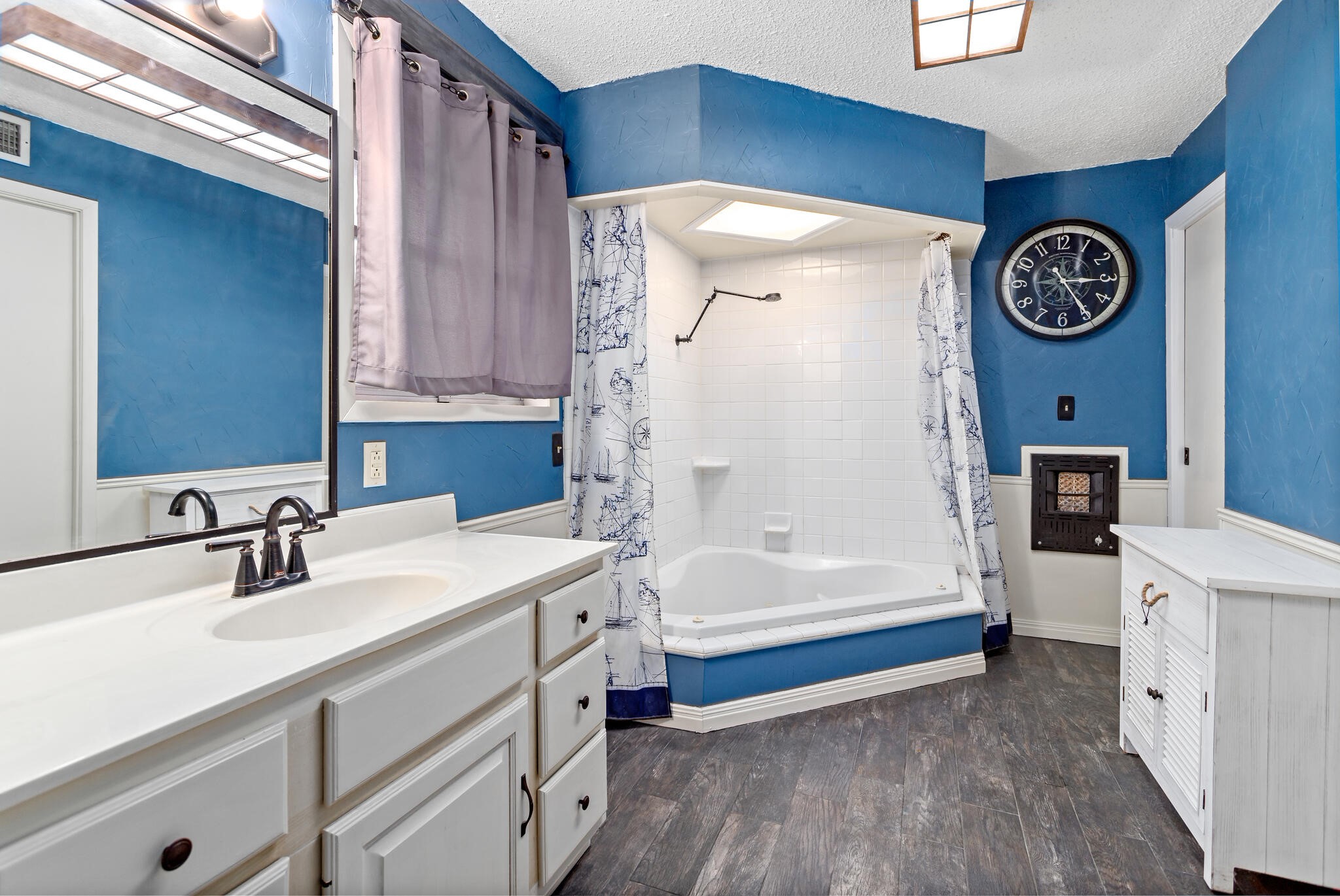 8600 Stonegate Court Port Arthur, TX 77642 - Photo 19 of 30 a bathroom with a tub a sink and a large mirror