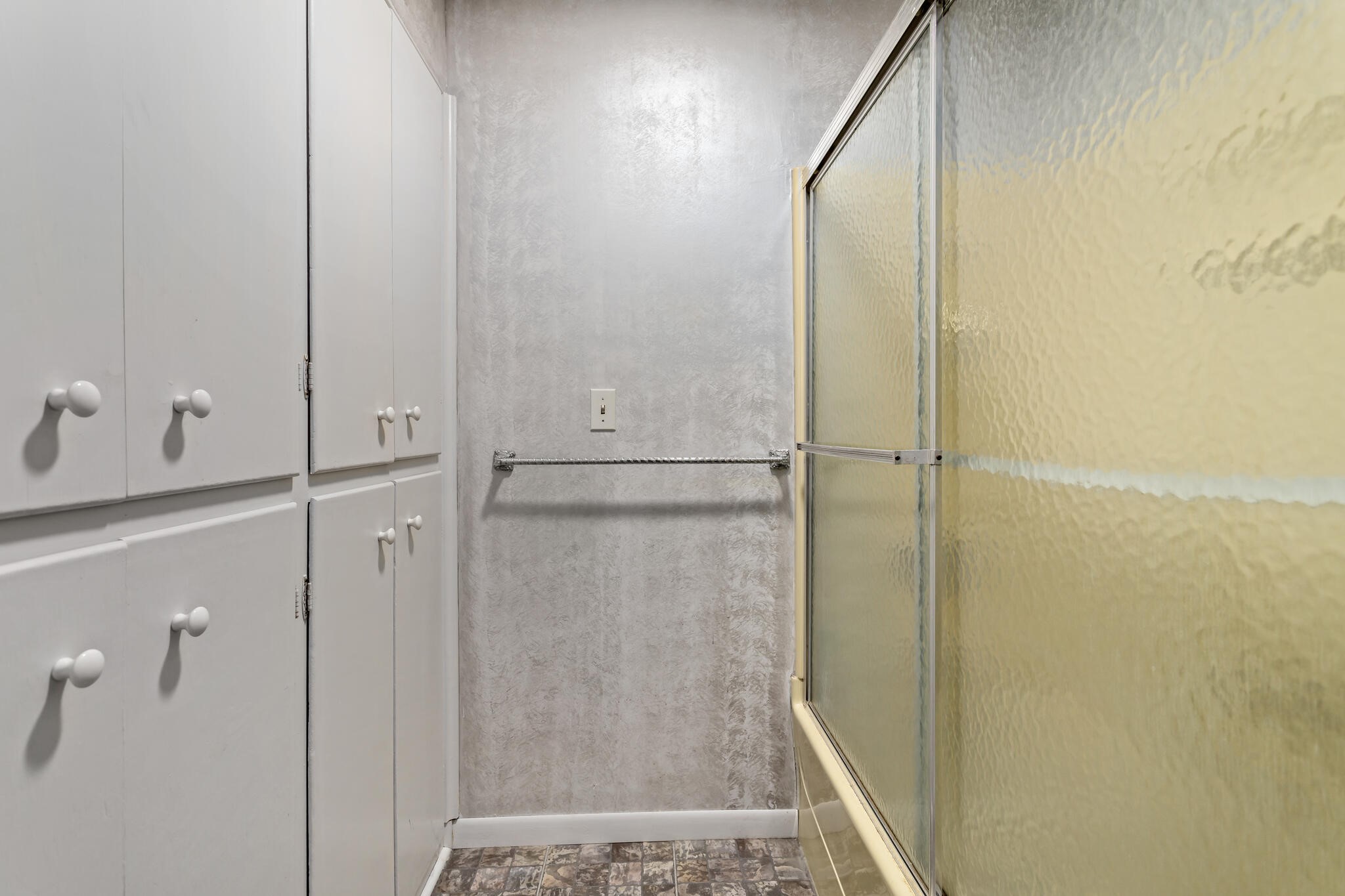 8600 Stonegate Court Port Arthur, TX 77642 - Photo 24 of 30 a bathroom with a glass shower door