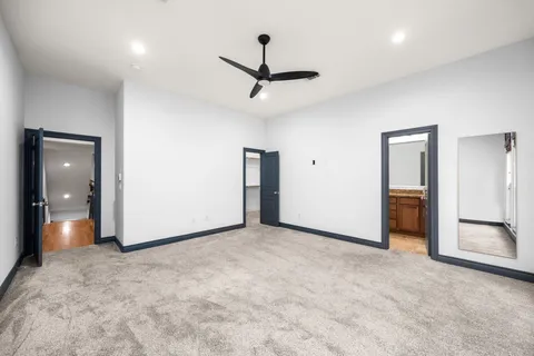 a view of an empty room and a ceiling fan