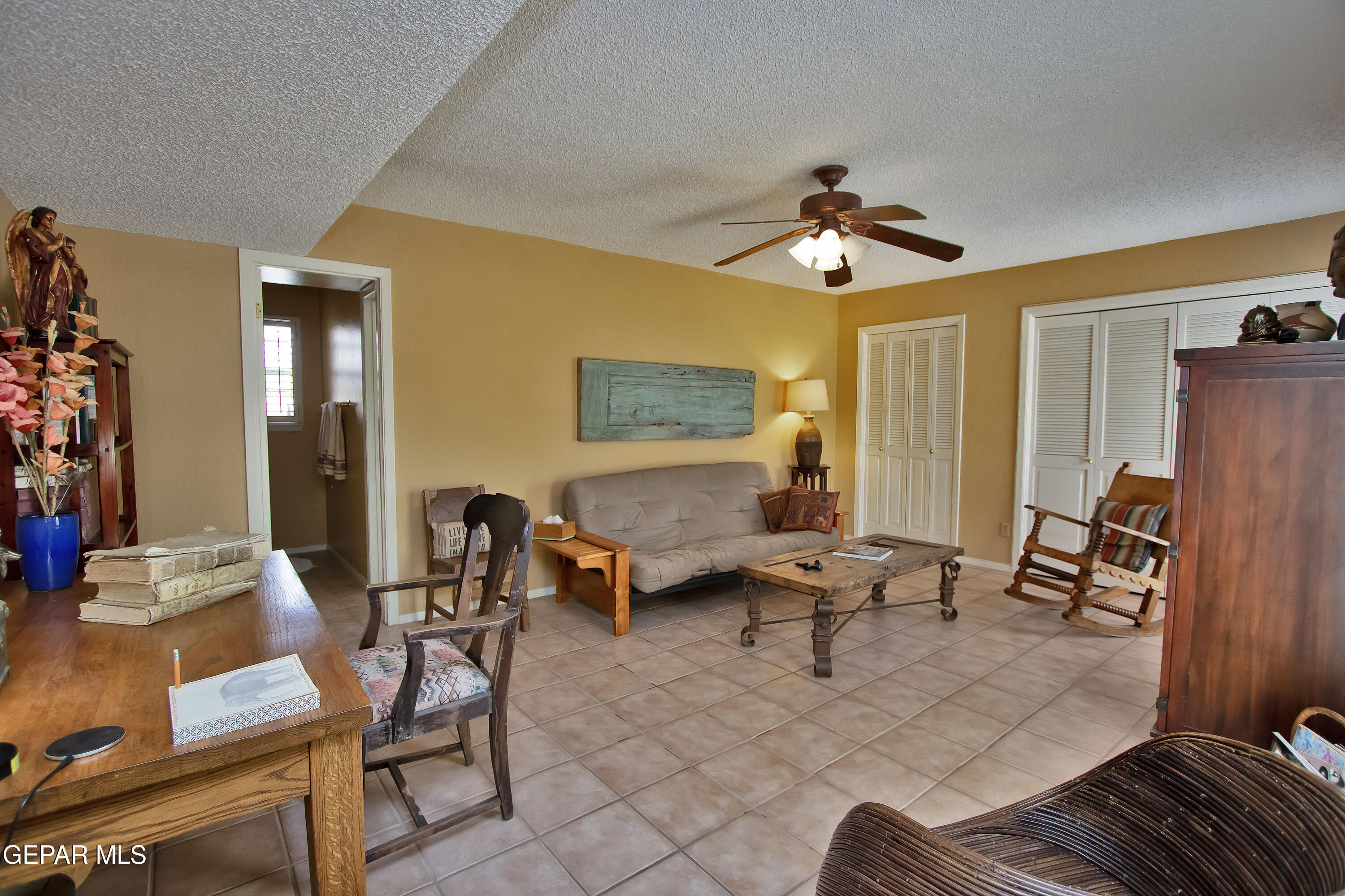 116 North Trevino Road Santa Teresa, NM 88008 - Photo 34 of 77 a living room with patio furniture and a chandelier