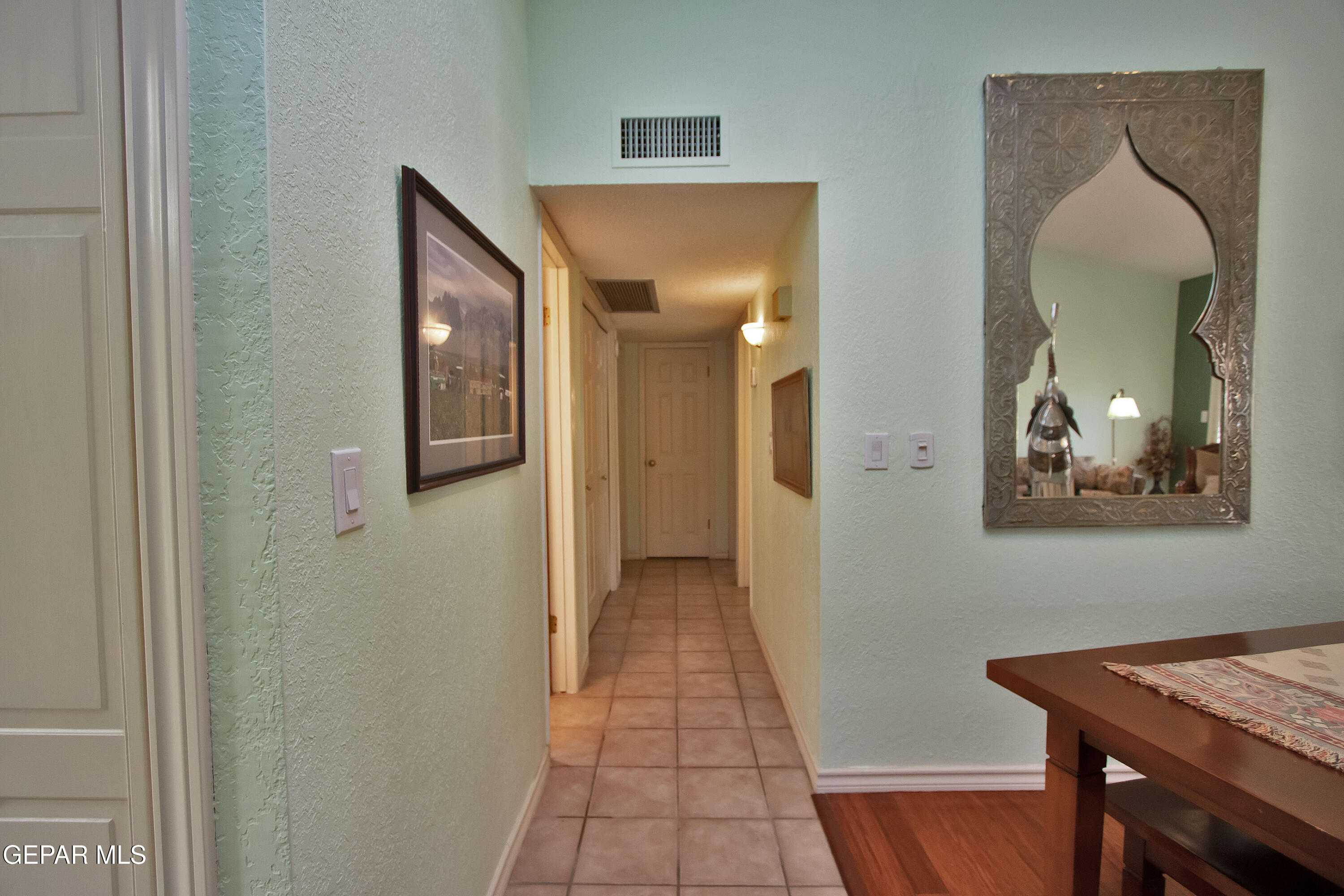 116 North Trevino Road Santa Teresa, NM 88008 - Photo 46 of 77 a view of a hallway with wooden floor and a livingroom view