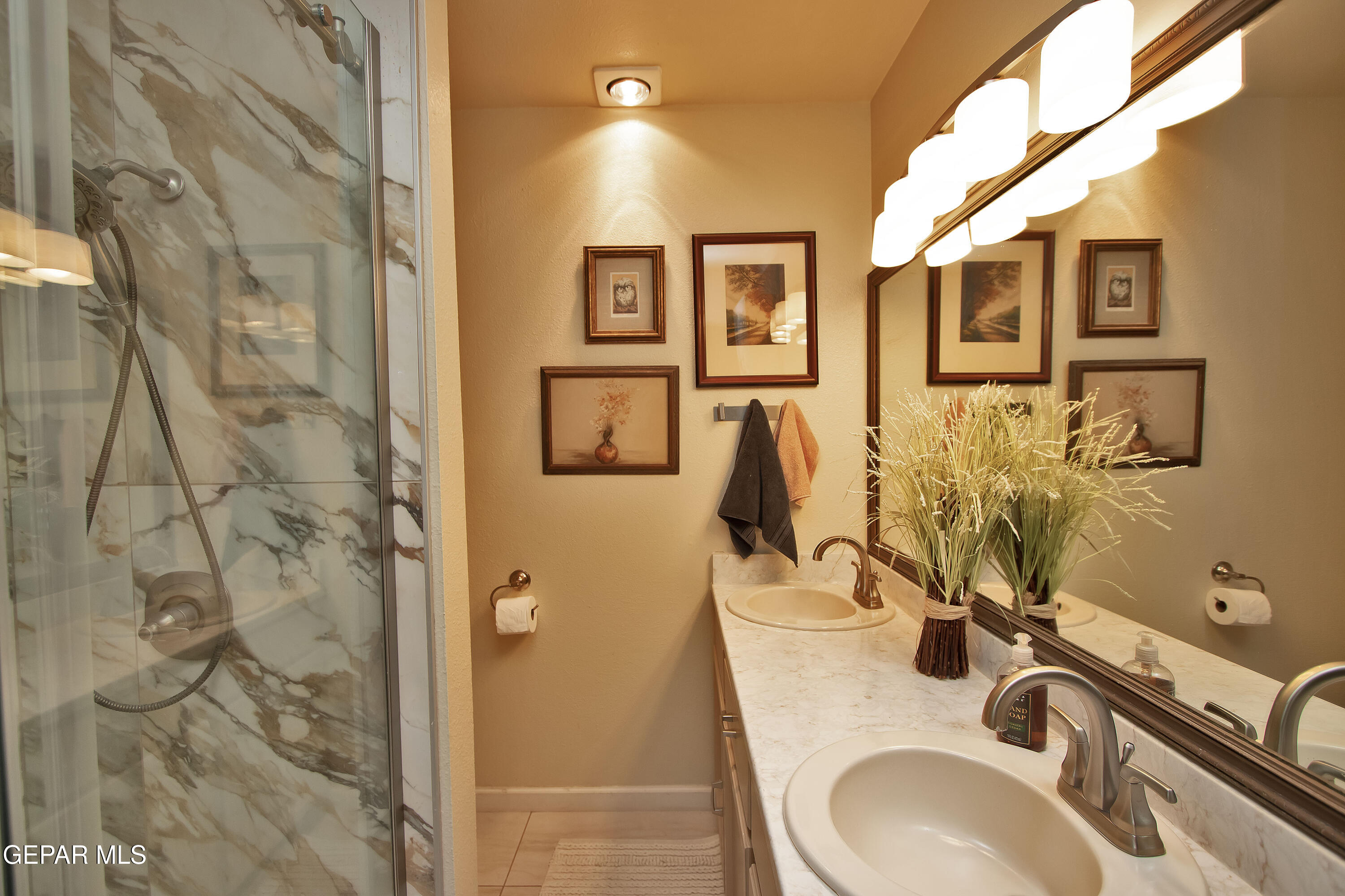 116 North Trevino Road Santa Teresa, NM 88008 - Photo 63 of 77 a bathroom with a granite countertop sink a mirror and shower