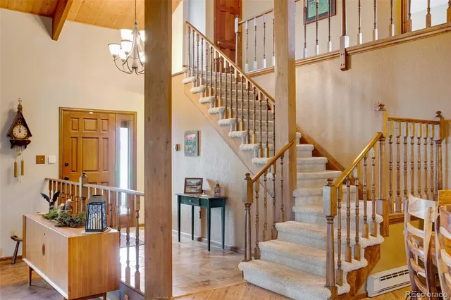 a kitchen with stainless steel appliances granite countertop wooden cabinets a sink and a large window