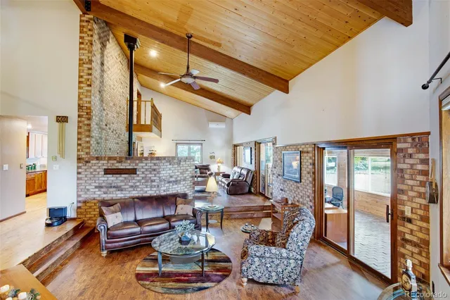 a dining room with furniture wooden floor and a potted plant